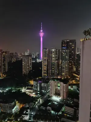 a view of a city at night with a tower at ROBERTSON RESIDENCE south SUITES IN KUALA LUMPUR in Kuala Lumpur