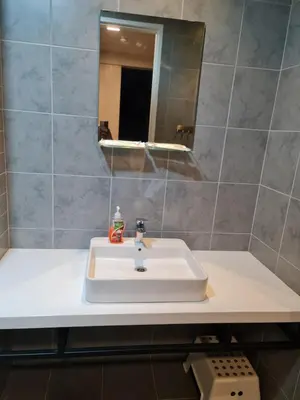 a bathroom with a white sink and a mirror at ROBERTSON RESIDENCE south SUITES IN KUALA LUMPUR in Kuala Lumpur