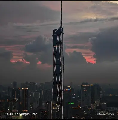 a tall skyscraper in a city at sunset at ROBERTSON RESIDENCE south SUITES IN KUALA LUMPUR in Kuala Lumpur