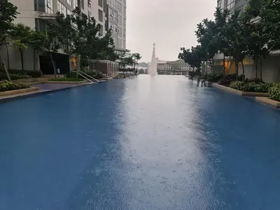 a long blue river in a city with buildings at ROBERTSON RESIDENCE south SUITES IN KUALA LUMPUR in Kuala Lumpur