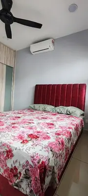 a bedroom with a bed with a red headboard at Maxim Citylights in Kuala Lumpur