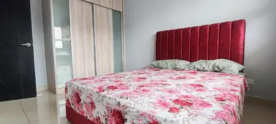 a bedroom with a bed with a red headboard at Maxim Citylights in Kuala Lumpur