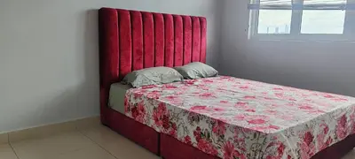 a bed with a red headboard in a room at Maxim Citylights in Kuala Lumpur