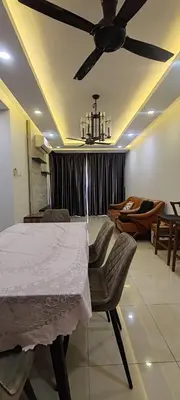 a dining room with a table and a ceiling fan at Maxim Citylights in Kuala Lumpur