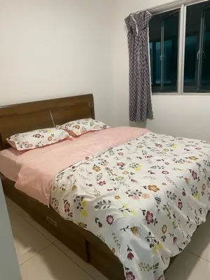 a bedroom with a bed with a comforter and pillows at DUDUhomes in Kuala Lumpur