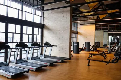 a gym with rows of treadles in a room at Hartamas Societe by MYAbnb in Kuala Lumpur