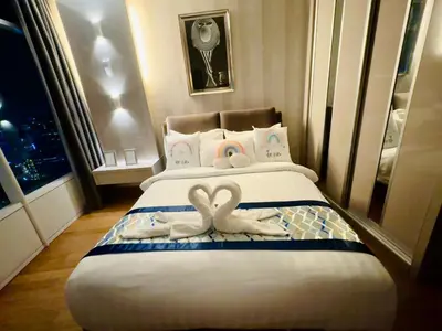 a bedroom with two swans towels on a bed at Vortex Suites Yonder Twin Tower in Kuala Lumpur