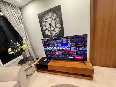 a clock and a television in a living room at Vortex Suites Yonder Twin Tower in Kuala Lumpur