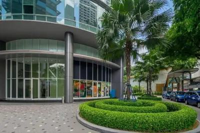a building with a palm tree in front of it at Vortex Suites Yonder Twin Tower in Kuala Lumpur