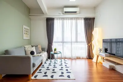a living room with a couch and a television at Menara Arina Uniti 3km to KLCC 2BR 4Pax Mini Home in Kuala Lumpur