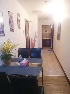 a dining room with a table and chairs and a hallway at Eastern Suites Times Square KL in Kuala Lumpur