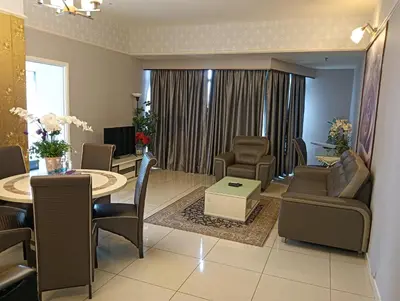 a living room with a table and chairs and a dining room at Eastern Suites Times Square KL in Kuala Lumpur
