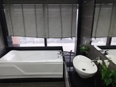 a bathroom with a white tub and a sink at Eastern Suites Times Square KL in Kuala Lumpur