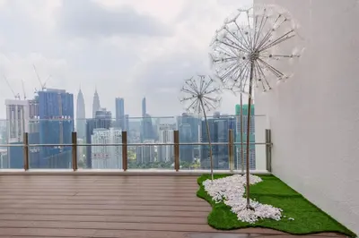 two windmills on a balcony with a view of a city at Agile Bukit Bintang KLCC by DX in Kuala Lumpur