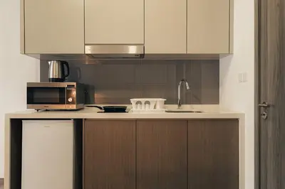 a kitchen with a sink and a microwave and a counter at Agile Bukit Bintang KLCC by DX in Kuala Lumpur
