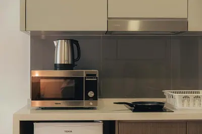 a microwave sitting on a counter in a kitchen at Agile Bukit Bintang KLCC by DX in Kuala Lumpur