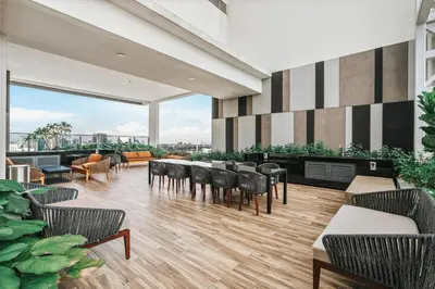 a restaurant with chairs and tables on a rooftop at LUXE Infinitum KLCC by DX in Kuala Lumpur