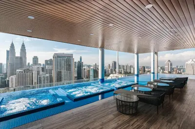 a swimming pool with a view of the city at LUXE Infinitum KLCC by DX in Kuala Lumpur