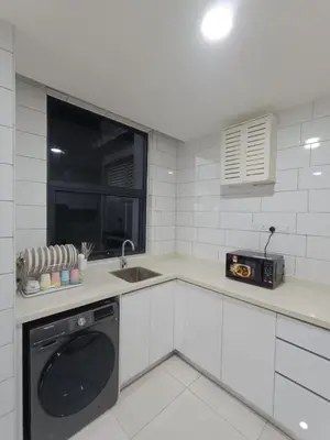 a kitchen with a dishwasher and a sink and a window at Arte Mont Kiara 4BR 8pax-10pax, 10mins to KLCC in Kuala Lumpur