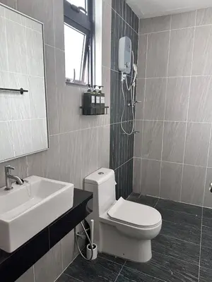 a bathroom with a white toilet and a sink at Home away from home near KLCC in Kuala Lumpur