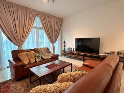 a living room with a couch and a flat screen tv at Home away from home near KLCC in Kuala Lumpur