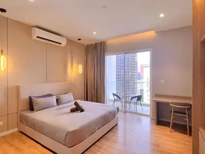 a bedroom with a large bed and a large window at Lovely & Comfy Quill Residence, Near Monorail& Quill City Mall in Kuala Lumpur