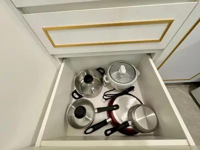 a drawer filled with pots and pans in a room at Axon Bukit Bintang Lovely 1BR Suite with KL View in Kuala Lumpur