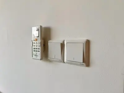 a wall with two switches on a wall at Axon Bukit Bintang Lovely 1BR Suite with KL View in Kuala Lumpur