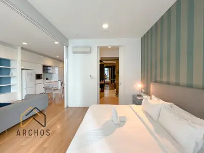 a bedroom with a bed and a living room at The Platinum KLCC by Archos in Kuala Lumpur