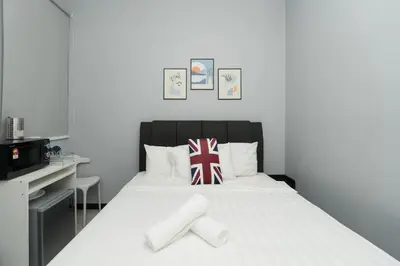 a bedroom with a bed with a british flag pillow at Backpackers Studio at Neu Suites Ampang in Kuala Lumpur
