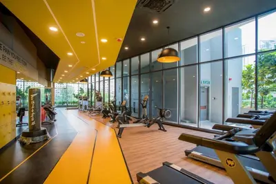 a gym with a lot of treadmills and exercise machines at Backpackers Studio at Neu Suites Ampang in Kuala Lumpur