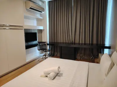 a hotel room with a bed with two towels on it at Platinum Kuala Lumpur by Sleepy Owl Suites in Kuala Lumpur