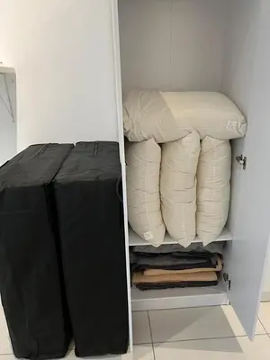 a white closet with a bunch of pillows in it at Matt suite home in Kuala Lumpur