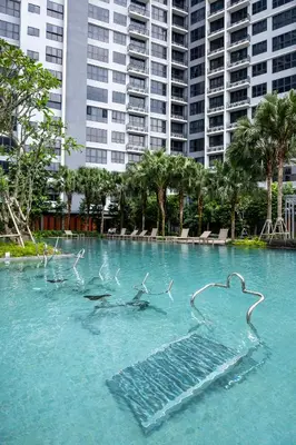 a group of birds swimming in a pool of water at Agile Bukit Bintang by KAN's in Kuala Lumpur