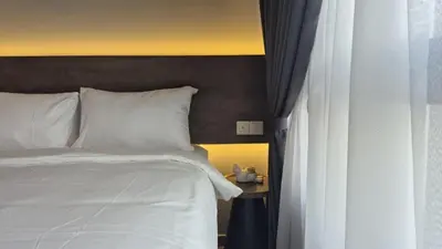 a bedroom with a white bed and a window at Agile Pavillion TRX Luxury Suited Kuala Lumpur Good View in Kuala Lumpur