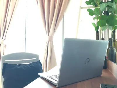 a laptop computer sitting on a table next to a window at Ampang 2 -3 pax Studio Ampang Point in Ampang
