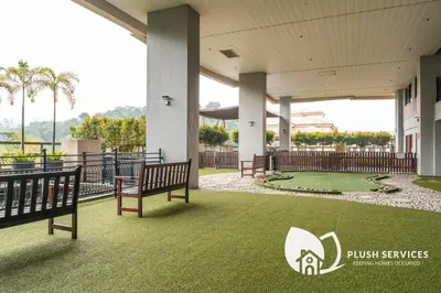 a building with two benches and a golf course at Windsor Tower Sri Hartamas by Plush in Kuala Lumpur