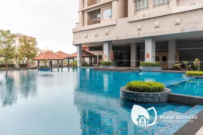a swimming pool in front of a building at Windsor Tower Sri Hartamas by Plush in Kuala Lumpur