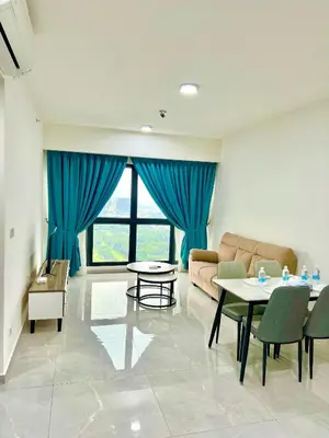 a living room with a couch and tables and blue curtains at Agile Residence TRX By Alltech Homes in Kuala Lumpur