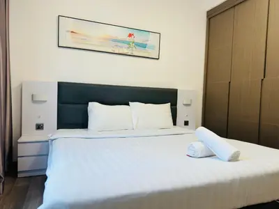 a bedroom with a large bed with white sheets at Agile Residence TRX By Alltech Homes in Kuala Lumpur
