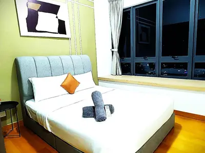 a bedroom with a bed with a bow tie on it at Agile Residence TRX By Alltech Homes in Kuala Lumpur