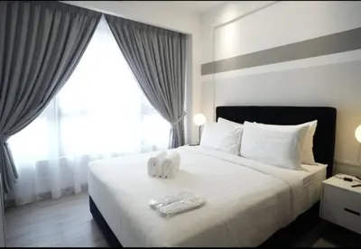 a hotel room with a bed with two towels on it at Agile Residence TRX By Alltech Homes in Kuala Lumpur