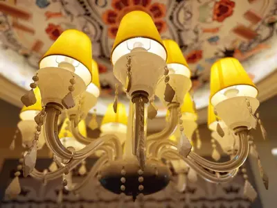 a chandelier with yellow lights hanging from a ceiling at Arte Mont Kiara 1-4 pax -MITEC-Kuala Lumpur by Infistay Homestay in Kuala Lumpur