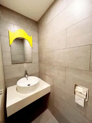 a bathroom with a sink and a yellow arrow on the wall at Arte Mont Kiara 1-4 pax -MITEC-Kuala Lumpur by Infistay Homestay in Kuala Lumpur