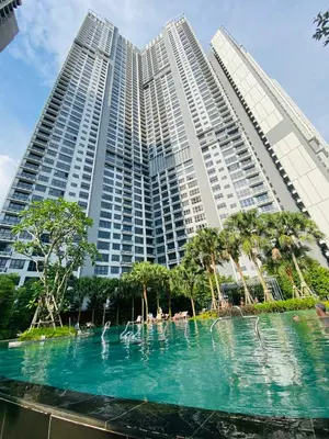 a swimming pool in front of a large building at Agile Sky Pavilion Residence KL TRX by Moonlight in Kuala Lumpur