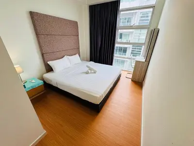 a hotel room with a bed and a large window at Soha Homestay in Kuala Lumpur