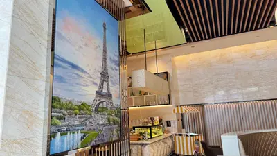 a mural of the eiffel tower on a wall in a restaurant at XING LUN KLCC Platinum Suites in Kuala Lumpur