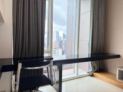 a glass table in front of a large window at XING LUN KLCC Platinum Suites in Kuala Lumpur