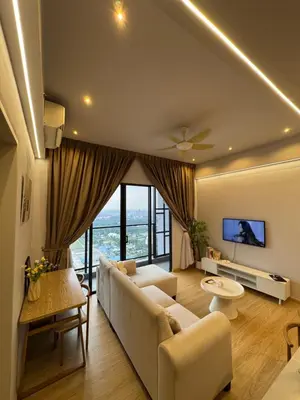a living room with a couch and a large window at trion kl TRX klcc view in Kuala Lumpur