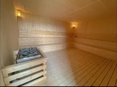 a large empty sauna with a wooden floor and wooden floors at trion kl TRX klcc view in Kuala Lumpur